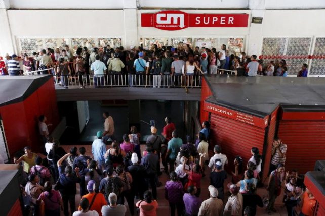 People line up for food items in Venezuela. Photo: Carlos Garcia Rawlins, Reuters 