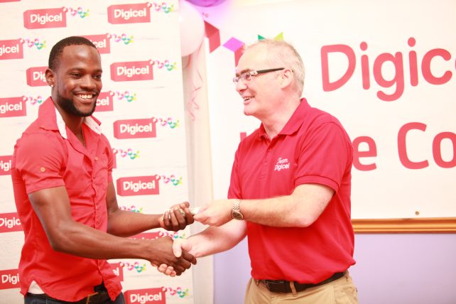 Digicel CFO Gerry McCarthy presents $2, 000 prize to Jingle Contest Winner Asher Thomas