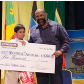 Hrishikesh Srinidasan from ST. Kitts Nevis with the OECS Managing Director Errol Leblanc, The winner of the OECS Reading Competition