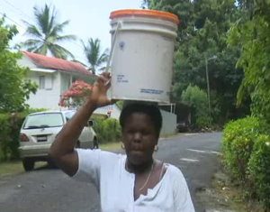 A caregiver fetches water. Photo:GIS