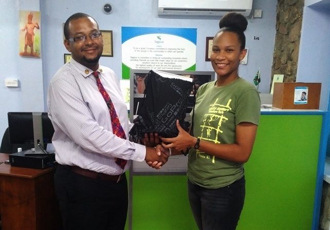 The winner receives her prize from Brenton Hiliare, Agency Manager
