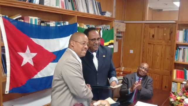 Darroux and the Cuban ambassador shake hands after the signing