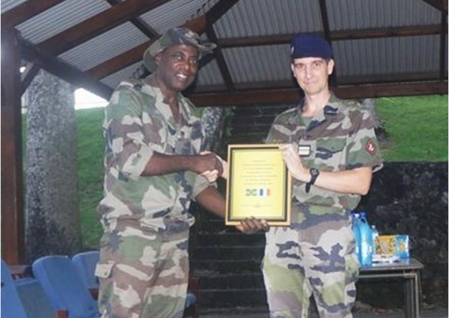 Maj. Christian presenting plaque of appreciation to French marine base commander
