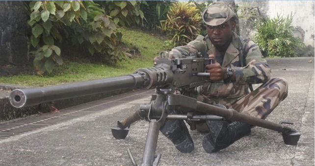 Sgt. Kish Charles braces behind the 50 caliber weapon