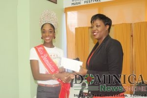 Miss Dominica makes a donation to assist students affected by Tropical Storm Erika