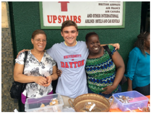 University of Dayton Engineering student with coconut delicacy vendors -  part of the ETHOS mission to revive Dominica’s coconut industry.