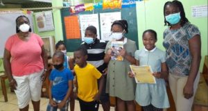 Book of stories written by children presented to some schools on island