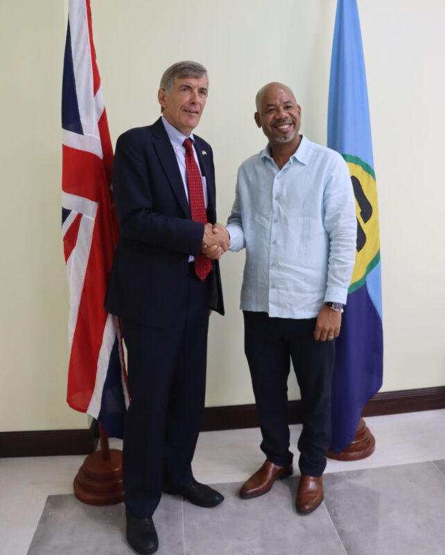 Foreign, Commonwealth and Development Office Minister for theCaribbean Mr. David Rutley shakes hands with the Executive Director of the CCCCC, Dr. Colin Young.