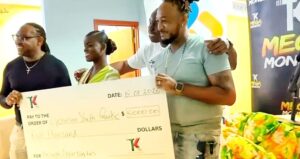 Marina Jno. Baptiste receives $5000 cheque from sponsors Triple Kay Band